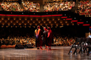 Graduates celebrate a commencement ceremony.